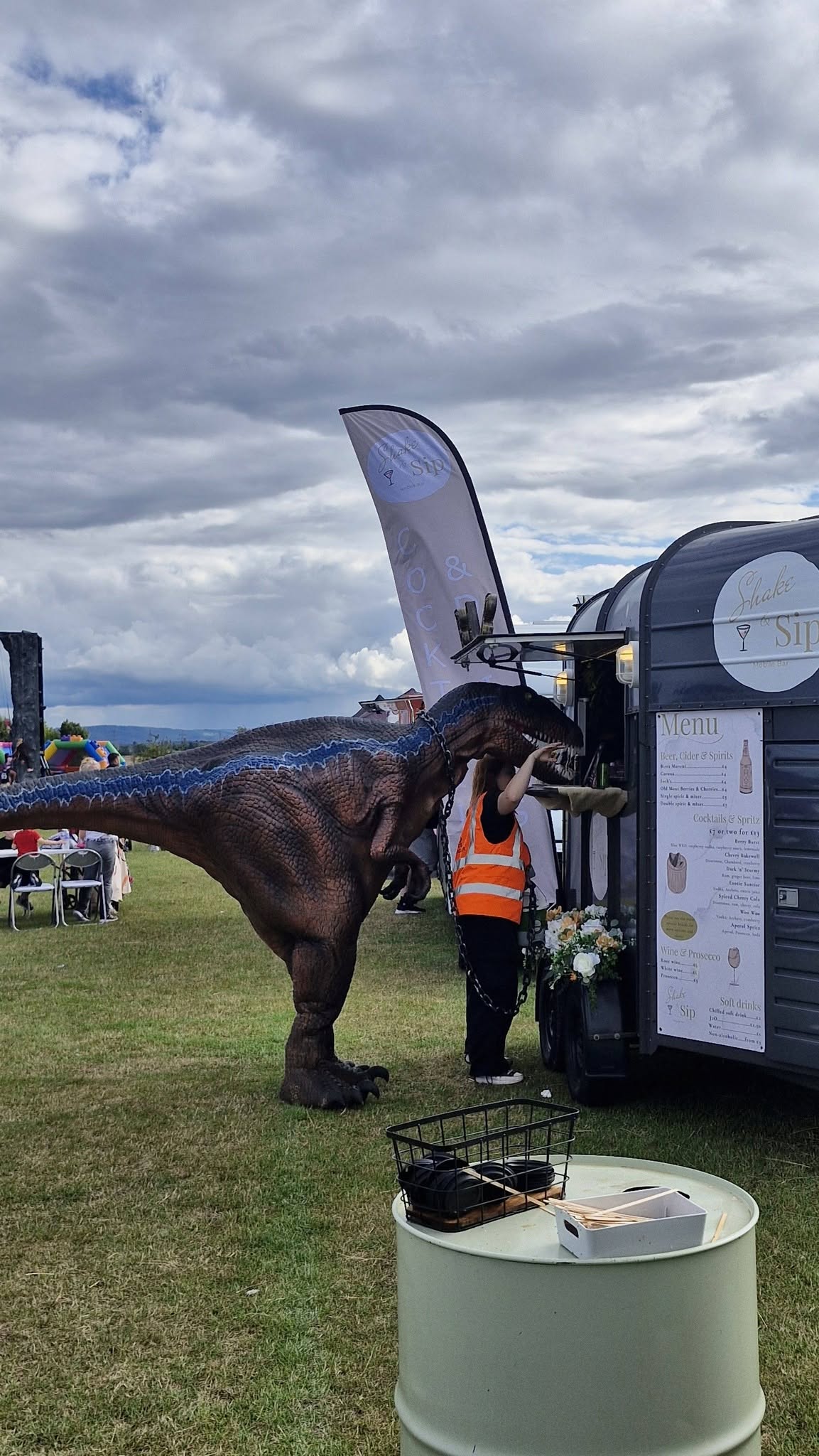 Dinosaur character visiting the Shake & Sip Horsebox Bar at an event