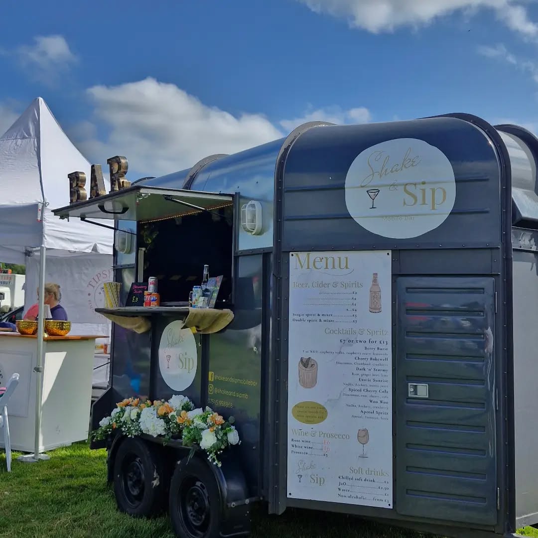 Shake & Sip Horsebox Bar dressed with flowers at an event