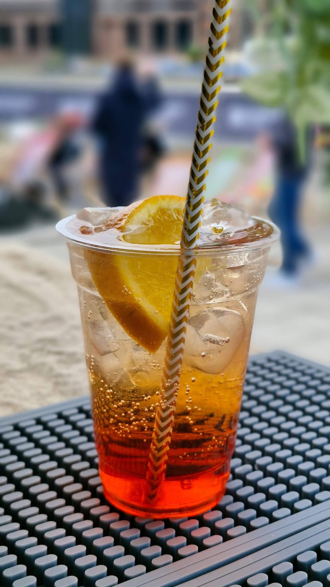 Spritz-style drink with orange garnish